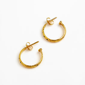A pair of textured gold hoop earrings with post backs, displayed on a clean white background.