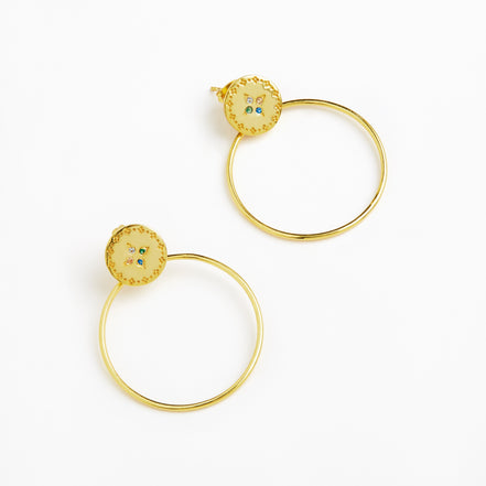A pair of gold hoop earrings with oval gold studs featuring a scalloped border and small blue and green enamel details, shown on a clean white background.