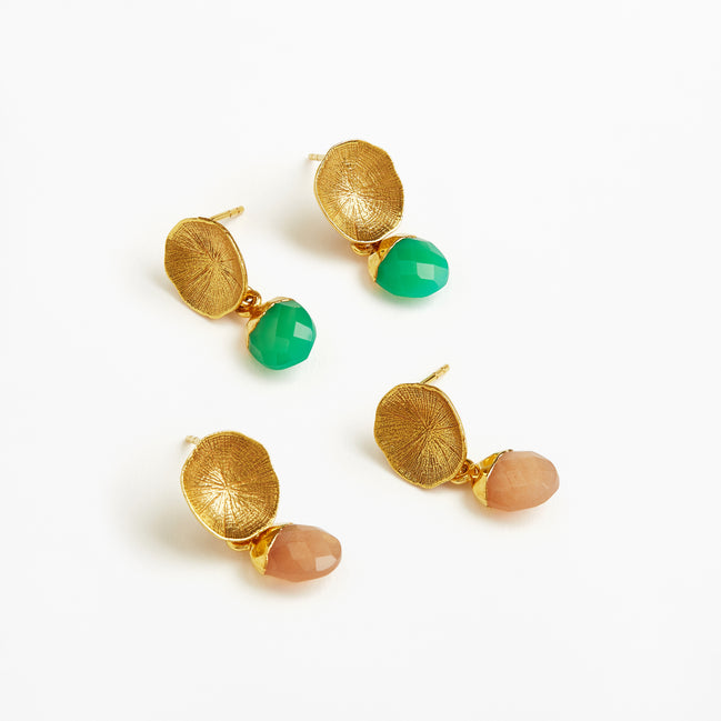 Four gold leaf drop earrings with green faceted beads and peach-colored teardrop beads, arranged on a clean white background.