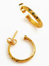 A pair of textured gold hoop earrings with small green and blue gemstone accents, displayed on a clean white background.