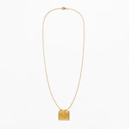 A delicate gold chain necklace featuring a small, textured square pendant, displayed against a clean white background.