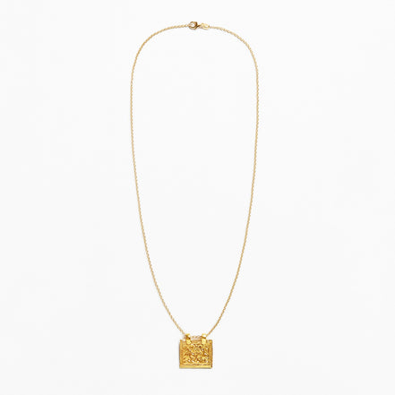 A delicate gold chain necklace featuring a small, textured square pendant, displayed against a clean white background.