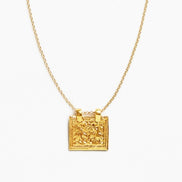 A gold chain necklace with a square pendant featuring an embossed lion design, shown against a plain white background.