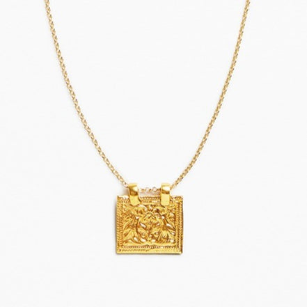 A gold chain necklace with a square pendant featuring an embossed lion design, shown against a plain white background.