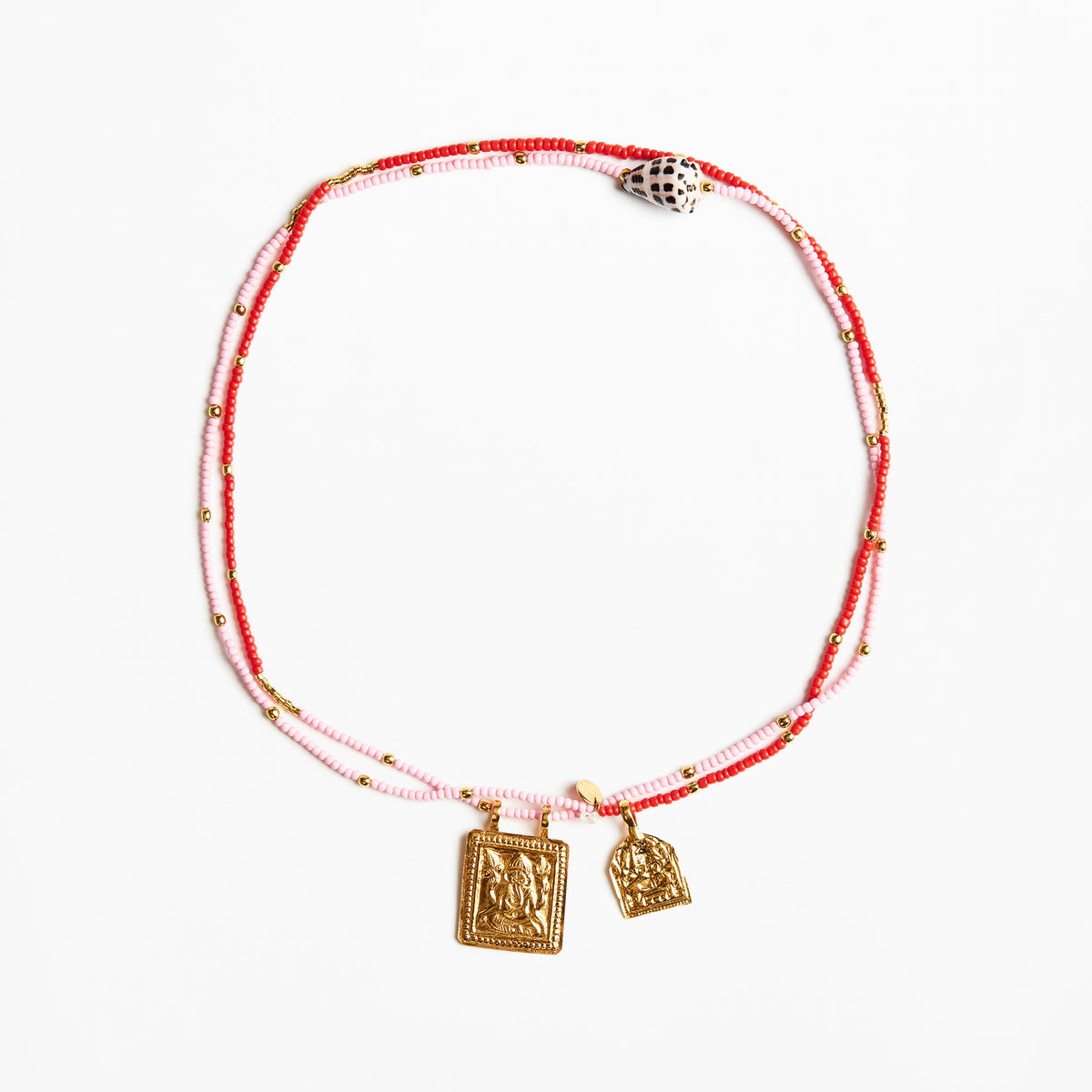 A delicate double-strand beaded necklace with red and light pink beads, small gold spacer beads, and two gold-toned pendant charms, displayed on a clean white background.