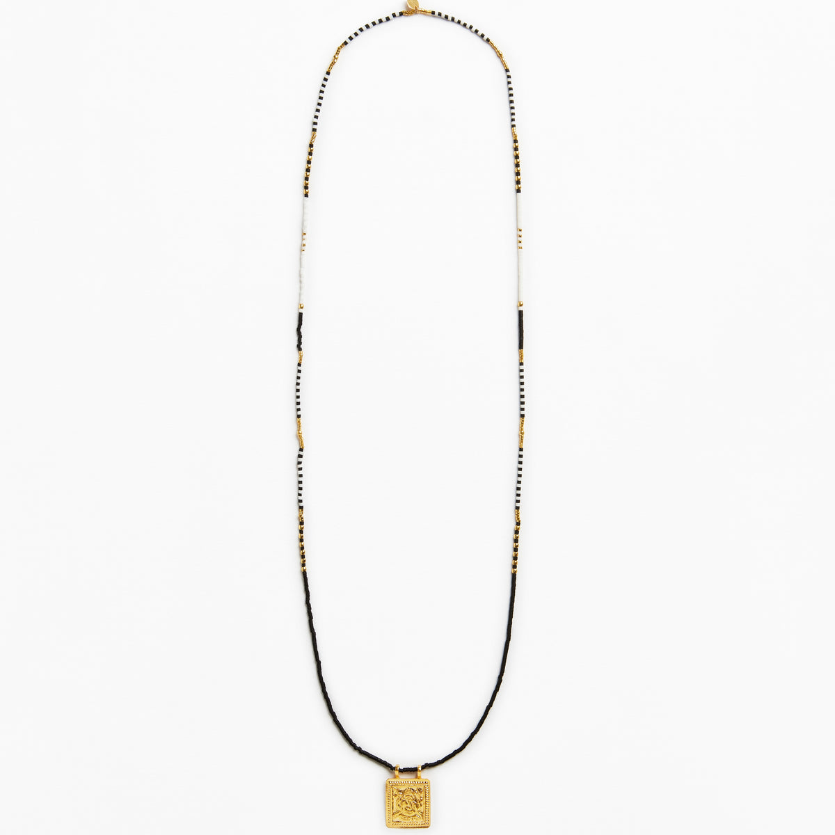 A long beaded necklace featuring a black cord base, accented with small white and gold beads, and finished with a square gold pendant at the bottom, shown against a plain white background.