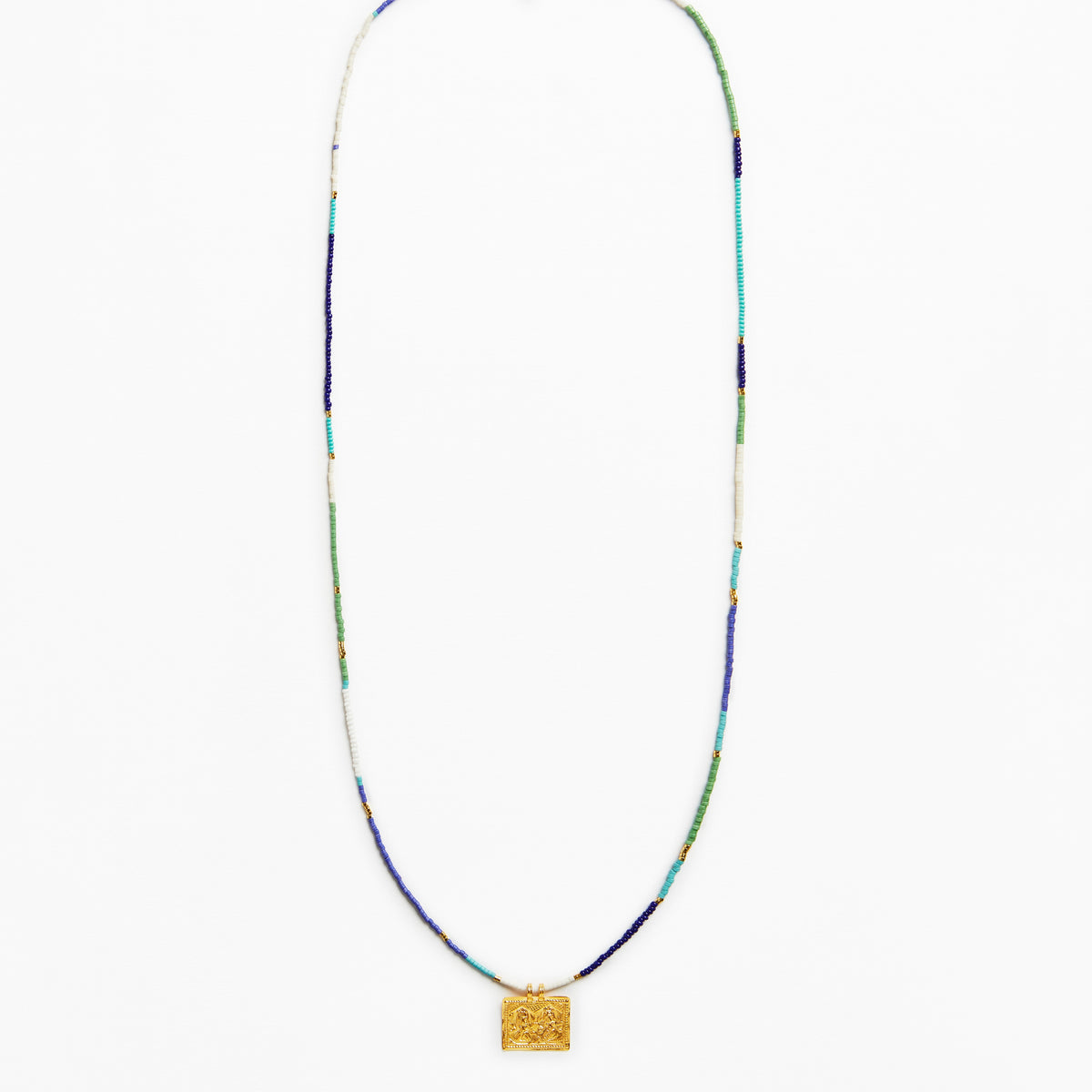 A long beaded necklace with a textured gold square pendant, featuring beads in blue, green, white, and gold.