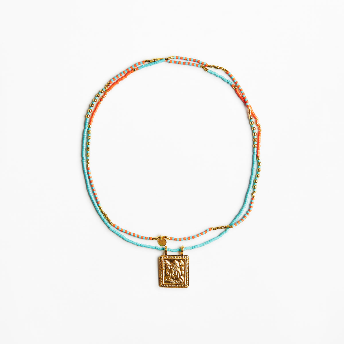 A delicate beaded necklace with turquoise, orange, and gold beads, featuring a square gold pendant with an embossed design, displayed on a clean white background.