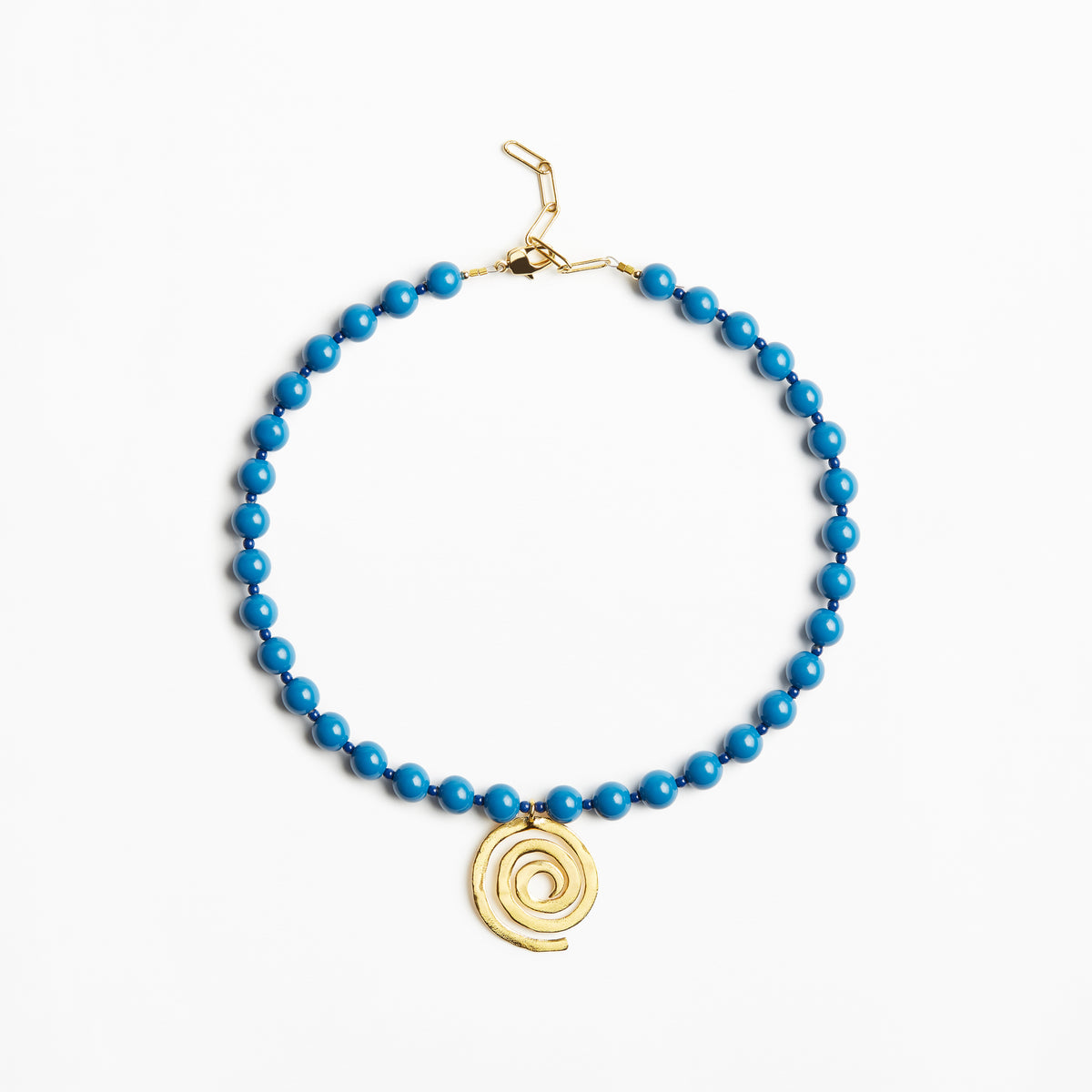 A beaded necklace featuring bright blue beads and a gold spiral pendant, displayed on a clean white background.