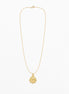 A delicate gold chain necklace with a small round ship's wheel pendant, displayed against a clean white background.