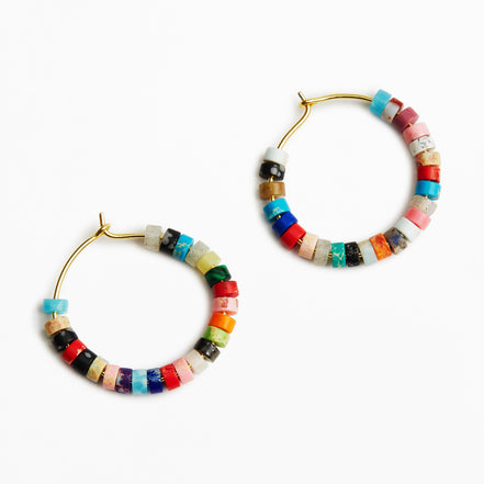 A pair of gold-tone hoop earrings decorated with small, colorful cylindrical beads in various patterns and colors, set against a plain white background.