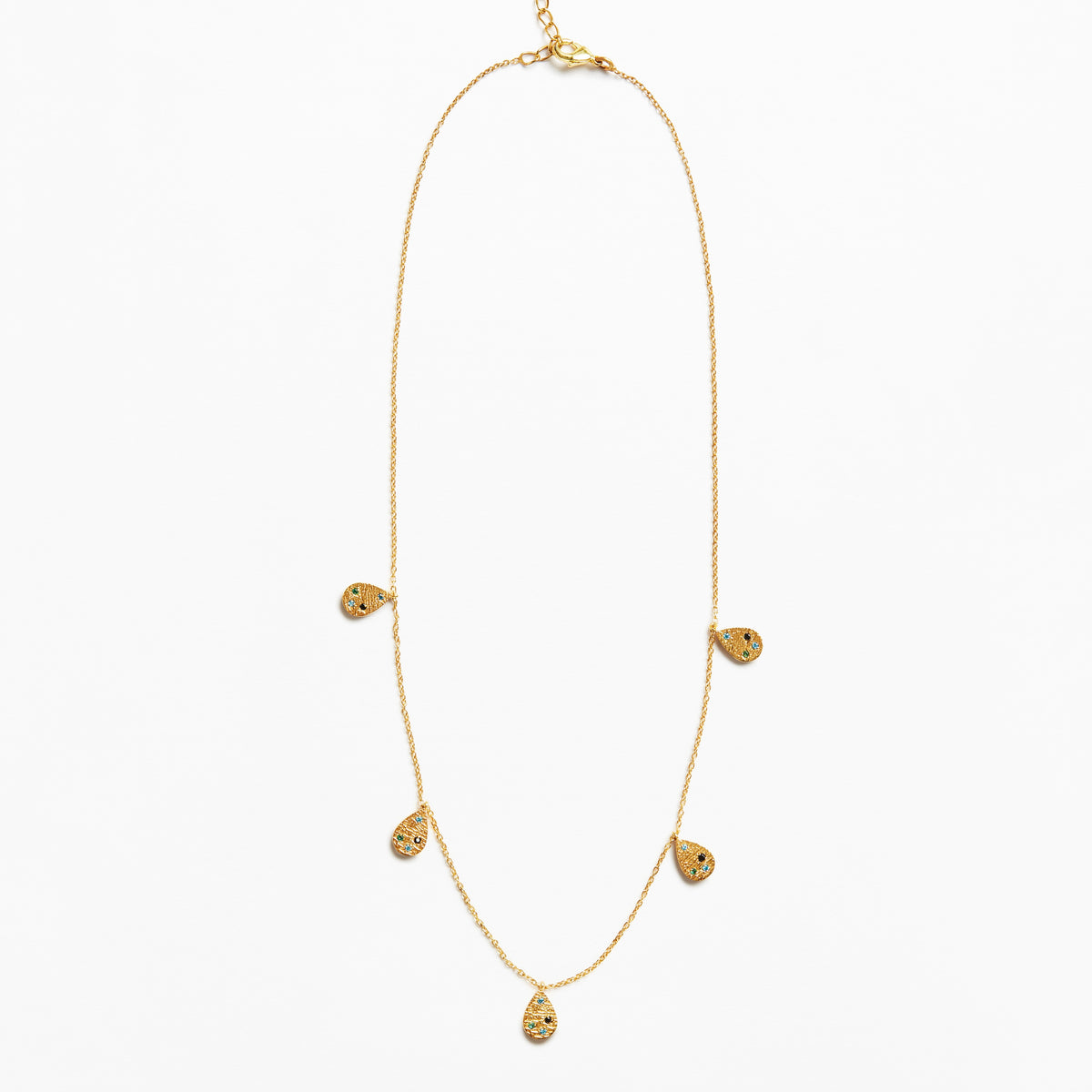 A delicate gold chain necklace featuring five small teardrop-shaped textured gold pendants spaced along the chain, displayed against a clean white background.