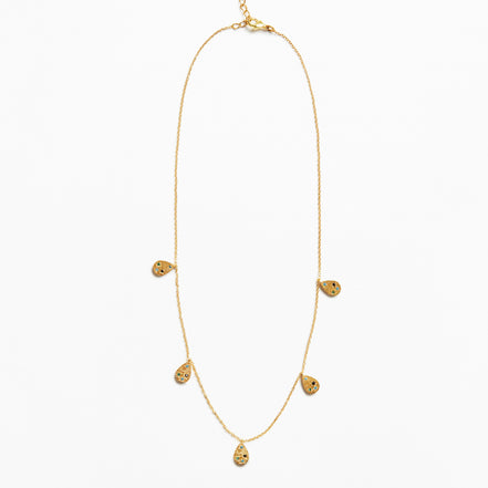 A delicate gold chain necklace featuring five small teardrop-shaped textured gold pendants spaced along the chain, displayed against a clean white background.