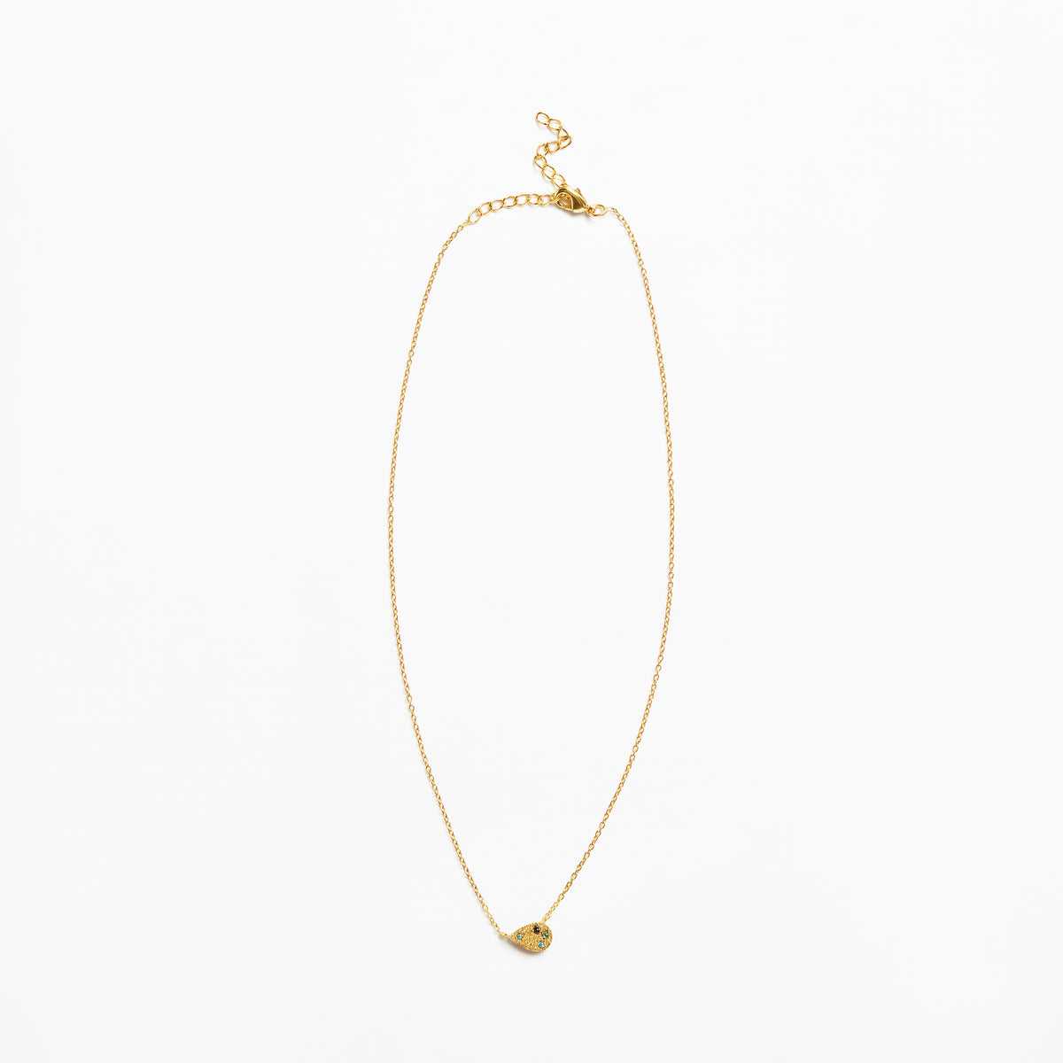 A delicate gold chain necklace with a small, textured gold heart-shaped pendant, displayed against a solid white background.