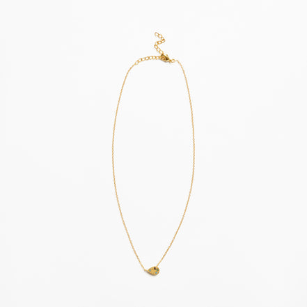 A delicate gold chain necklace with a small, textured gold heart-shaped pendant, displayed against a solid white background.